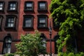 Row of Beautiful Old Brick Residential Buildings with Green Trees in the East Village of New York City Royalty Free Stock Photo