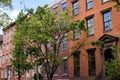 Row of Old Colorful Brick Residential Buildings along a Street in Chelsea of New York City Royalty Free Stock Photo