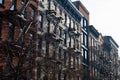 Row of Beautiful Old Residential Buildings with Fire Escapes in Nolita of New York City