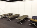 Row of beds are lined up against a wall, refugee camp in Cologne Royalty Free Stock Photo