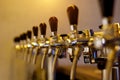 A row of beer taps in a bar