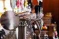 A row of beer taps in a beer bar close-up. Beer bottling in the restaurant. Royalty Free Stock Photo