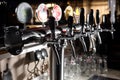 A row of beer taps in a beer bar close-up. Beer bottling in the restaurant. Royalty Free Stock Photo