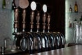 Row of beer taps on a stainless steel keg in a pub Royalty Free Stock Photo
