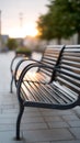 A row of benches sitting on a sidewalk in a park Royalty Free Stock Photo