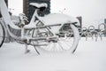 Row of bicycles covered with snow at the street Royalty Free Stock Photo