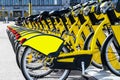 Row of bicycles parked. Row of parked colorful bicycles. Rental yellow bicycles. Pattern of vintage bicycles bikes for rent on sid