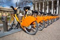 Row of bikes parked for hire, city bikes rent parking, public bicycle sharing system