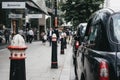 Row of Black cabs parked on a side of the road in City of London, London, UK. Royalty Free Stock Photo