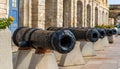 Row of black cannons along the waterfront in Birgu, Malta