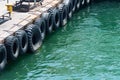 Row of black car tires used as boat bumpers