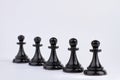 Row of black chess pieces isolated on white background. Royalty Free Stock Photo