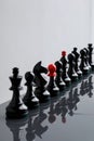 Row of black chess pieces on a light, minimalistic background Royalty Free Stock Photo