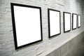 Row of black frames on white brick wall Royalty Free Stock Photo