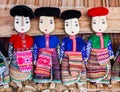 Row of black and red Dzao wooden dolls Royalty Free Stock Photo