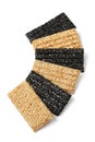 Row of black and white sesame snaps on white background close up