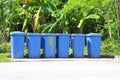 Row of blue dustbin by the roadside Royalty Free Stock Photo