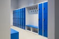 Blue Lockers On A Wall With Key In A Lock And A Bench