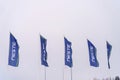 Row of Blue Neste Flags Fluttering Against a Cloudy Sky Royalty Free Stock Photo
