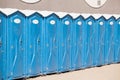 Row of blue portable, mobile toilets