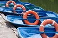 Blue rental boats with Lifebuoy on a pier
