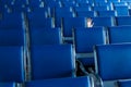 Row of blue seats and a human hand in airport hall Royalty Free Stock Photo