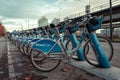 Row of blue Shaw Go Mobi bikes lined up near skytrain in Downtown Vancouver Canada