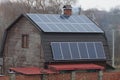 Row of blue solar panels on gray tiled roof