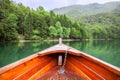 Row boat floating on green water of the glacial Biograd lake. Montenegro, Europe Royalty Free Stock Photo