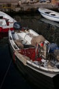 a row boat with netting hanging out of the deck, filled with lobsters