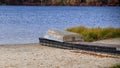 Row boat upside down on dock on sandy beach Royalty Free Stock Photo