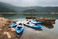 Row Boats and Kayaks on Morning Mountain Lake Royalty Free Stock Photo