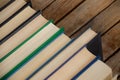 Row of books. A row of books on a wooden table with place for text. One book nominated