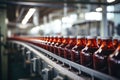 A row of bottles is being transported on a conveyor belt in a manufacturing facility, Process of beverage manufacturing on a