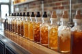 Row of bottles containing iced teas and coffees is arrayed across a bar counter, displaying a spectrum of hues from Royalty Free Stock Photo