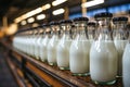 A row of bottles of milk on a conveyor belt.