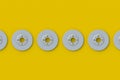 Row of brake discs on yellow background