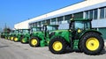 Row of brand new John Deere tractors outside the store of local consortium, exhibition of latest agricultural machinery. Royalty Free Stock Photo