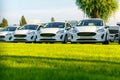Row of brand new white cars in stock at the car dealership Royalty Free Stock Photo