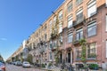 a row of brick apartment buildings with bikes parked outside