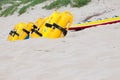 Row of bright yellow floatation devices on beach Royalty Free Stock Photo