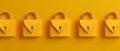 Row of bright yellow padlocks arranged against matching yellow background symbolizing security protection modern design