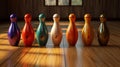 Colored bowling pins in a row on wooden floor Royalty Free Stock Photo