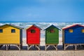 Row of brightly colored huts in Muizenberg beach. Muizenberg Royalty Free Stock Photo