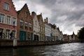 Row of Bruges city architectures with waterfront under cloudy sky in Belgium Royalty Free Stock Photo