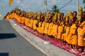 Row of Buddhist hike monks on street. Royalty Free Stock Photo