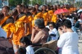 Row of Buddhist hike monks on street. Royalty Free Stock Photo