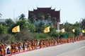 Row of Buddhist hike monks on street. Royalty Free Stock Photo