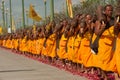 Row of Buddhist hike monks on street. Royalty Free Stock Photo