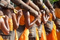 Row of Buddhist hike monks on street. Royalty Free Stock Photo